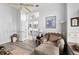 Comfortable living room featuring a ceiling fan and a doorway that leads to another room at 6408 Whit Ct, Port Orange, FL 32128