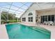 Outdoor pool featuring a screened enclosure, a patio, and manicured lawn at 6408 Whit Ct, Port Orange, FL 32128