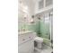 Charming bathroom showcasing a shower with green tiles and a pedestal sink at 761 Greenway Pl, Daytona Beach, FL 32114