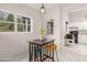 Bright breakfast nook featuring a small table with stools, a window, and kitchen access at 761 Greenway Pl, Daytona Beach, FL 32114