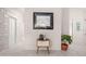 Bright hallway with stylish decor, a decorative table, an art piece, and clean tile flooring at 761 Greenway Pl, Daytona Beach, FL 32114