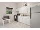 Bright kitchen featuring white cabinets, sleek appliances, a window, and ample counter space at 761 Greenway Pl, Daytona Beach, FL 32114
