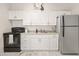 Well-maintained kitchen featuring white cabinetry, granite countertops, and modern appliances at 761 Greenway Pl, Daytona Beach, FL 32114