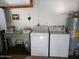 Functional laundry room equipped with a washer, dryer, and additional storage at 761 Greenway Pl, Daytona Beach, FL 32114
