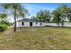 Expansive backyard features a partial privacy fence, mature trees, and plentiful space for outdoor activities at 815 Charles Ave, Orange City, FL 32763