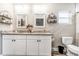 Bright bathroom features double vanity with granite countertop, stylish mirrors and convenient toilet placement at 815 Charles Ave, Orange City, FL 32763