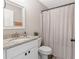 Bright bathroom features single vanity with granite countertop, stylish mirror and a shower with curtain at 815 Charles Ave, Orange City, FL 32763
