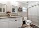 Bright bathroom features double vanity with granite countertop, stylish mirrors and a shower with curtain at 815 Charles Ave, Orange City, FL 32763