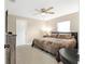 Cozy bedroom features comfortable bed, neutral colors, ceiling fan and a window for natural light at 815 Charles Ave, Orange City, FL 32763