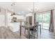 Dining area with modern lighting and convenient access to the kitchen and outdoor spaces at 815 Charles Ave, Orange City, FL 32763