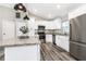 Stylish kitchen featuring white cabinets, granite countertops, and stainless steel appliances at 815 Charles Ave, Orange City, FL 32763