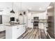 Contemporary kitchen featuring stainless steel appliances, island, and white cabinetry at 815 Charles Ave, Orange City, FL 32763