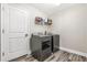 Functional laundry room features wood plank flooring, updated appliances and convenient shelving at 815 Charles Ave, Orange City, FL 32763
