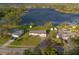Aerial shot of the home showcasing its location, with well-maintained landscaping and proximity to the lake at 902 Cloverleaf Blvd, Deltona, FL 32725