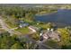 The aerial shot captures the home's expansive surroundings, including mature trees and proximity to the lake at 902 Cloverleaf Blvd, Deltona, FL 32725