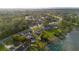 Expansive aerial view of a lakeside community, featuring lush greenery and serene water views, single-Gathering homes and mature landscaping at 902 Cloverleaf Blvd, Deltona, FL 32725