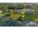 Scenic backyard with mature trees, lush green grass, lake views, and access to the water, perfect for outdoor enjoyment at 902 Cloverleaf Blvd, Deltona, FL 32725