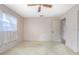 A bedroom with beige walls, light carpet, and a window at 902 Cloverleaf Blvd, Deltona, FL 32725