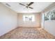 A bedroom with two windows, neutral walls, a ceiling fan, and light brown carpet at 902 Cloverleaf Blvd, Deltona, FL 32725