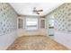 Dining room with decorative wallpaper, a ceiling fan, built-in corner cabinets, and a view into the kitchen at 902 Cloverleaf Blvd, Deltona, FL 32725