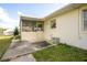 Exterior view of the home featuring a partially screened-in patio and a well-maintained lawn at 902 Cloverleaf Blvd, Deltona, FL 32725