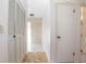 Interior hallway view with tile flooring, a closet with louvered doors, and entry to the bathroom at 902 Cloverleaf Blvd, Deltona, FL 32725