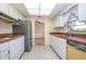 View of kitchen, featuring sleek appliances, a bright skylight, and a convenient pass-through to the dining area at 902 Cloverleaf Blvd, Deltona, FL 32725