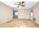A living room featuring neutral walls, a ceiling fan, and a doorway leading to another room at 902 Cloverleaf Blvd, Deltona, FL 32725
