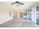 Inviting and bright living area featuring neutral tile flooring, light walls and sliding glass door to screened patio at 902 Cloverleaf Blvd, Deltona, FL 32725