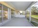 The screened-in patio offers a peaceful retreat with views of the spacious backyard and lovely landscaping at 902 Cloverleaf Blvd, Deltona, FL 32725