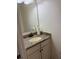 Granite vanity top and off-white cabinets in bathroom featuring a decorative mirror at 1812 Leather Fern Dr, Ocoee, FL 34761