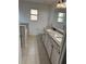 Well-lit bathroom featuring double vanities with granite tops and tile flooring at 1812 Leather Fern Dr, Ocoee, FL 34761