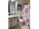 Bathroom with granite countertops and floral shower curtain at 1812 Leather Fern Dr, Ocoee, FL 34761