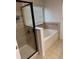 Shower and tub combo with tiled walls, a glass shower door, and decorative trim at 1812 Leather Fern Dr, Ocoee, FL 34761