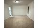 Spacious bedroom with neutral carpet, light walls, and a bright ceiling light at 1812 Leather Fern Dr, Ocoee, FL 34761