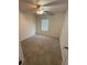 Cozy bedroom with plush carpeting, a ceiling fan, and a window for natural light at 1812 Leather Fern Dr, Ocoee, FL 34761