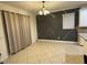 Inviting dining room featuring a geometric accent wall, neutral tile flooring, and natural light at 1812 Leather Fern Dr, Ocoee, FL 34761