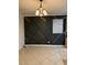 Dining room with a designer accent wall, chandelier, and tiled floors at 1812 Leather Fern Dr, Ocoee, FL 34761