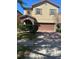 Charming two-story home with brick driveway, archway and beautiful shrubbery at 1812 Leather Fern Dr, Ocoee, FL 34761
