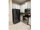 Stainless steel refrigerator, oven, and microwave with tile backsplash and granite counters at 1812 Leather Fern Dr, Ocoee, FL 34761