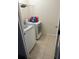 Tiled laundry room with a washer and dryer and plenty of space for folding at 1812 Leather Fern Dr, Ocoee, FL 34761