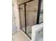 Tile shower stall with a glass door and black hardware, complemented by tile accents at 1812 Leather Fern Dr, Ocoee, FL 34761