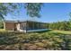 Exterior view of the screened patio, with a spacious backyard at 1020 Alladin Dr, Deltona, FL 32725