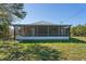 Spacious yard featuring a screened in porch at 1020 Alladin Dr, Deltona, FL 32725