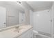 Bathroom featuring a large mirror and a shower with white tiling at 1020 Alladin Dr, Deltona, FL 32725