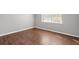 This well-lit bedroom features laminate hardwood floors and a large window allowing natural light at 1020 Alladin Dr, Deltona, FL 32725