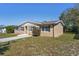 Charming single-story home featuring a well-maintained lawn and classic architectural details at 1020 Alladin Dr, Deltona, FL 32725