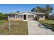 Charming single-story home featuring a well-manicured lawn, tidy landscaping, and a welcoming front entrance at 1020 Alladin Dr, Deltona, FL 32725