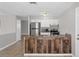 Stylish kitchen features a stainless steel refrigerator, granite counters, and ample cabinet space at 1020 Alladin Dr, Deltona, FL 32725