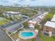 Aerial view of community with a pool, parking, landscaping, and nearby buildings at 108 Mitchell Pl # 108, Daytona Beach, FL 32118